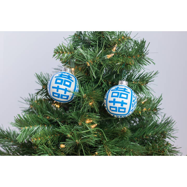 Hand-painted ceramic ornament featuring a red double happiness symbol on a white spherical silhouette.