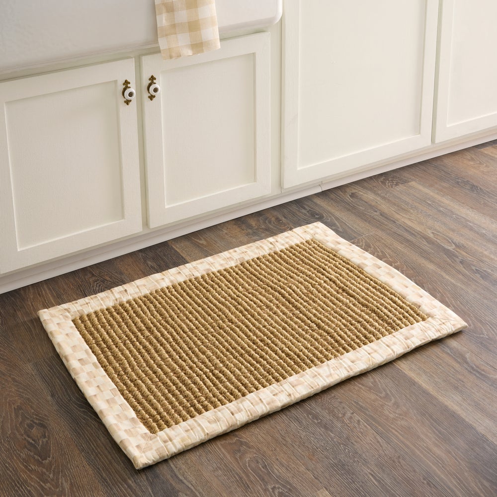 Mocha Check 2' x 3' Chunky Sisal Rug with a woven cotton border on a dark wood floor.