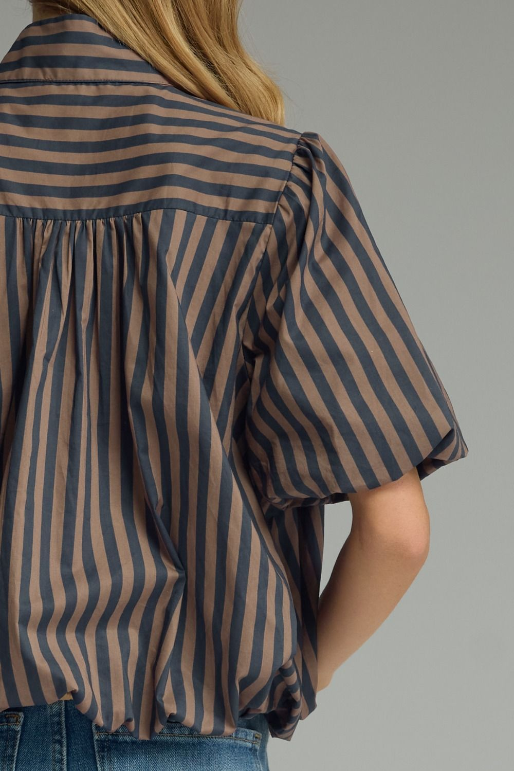 Back view of a brown and navy striped cotton top with short puff sleeves and shirring details.