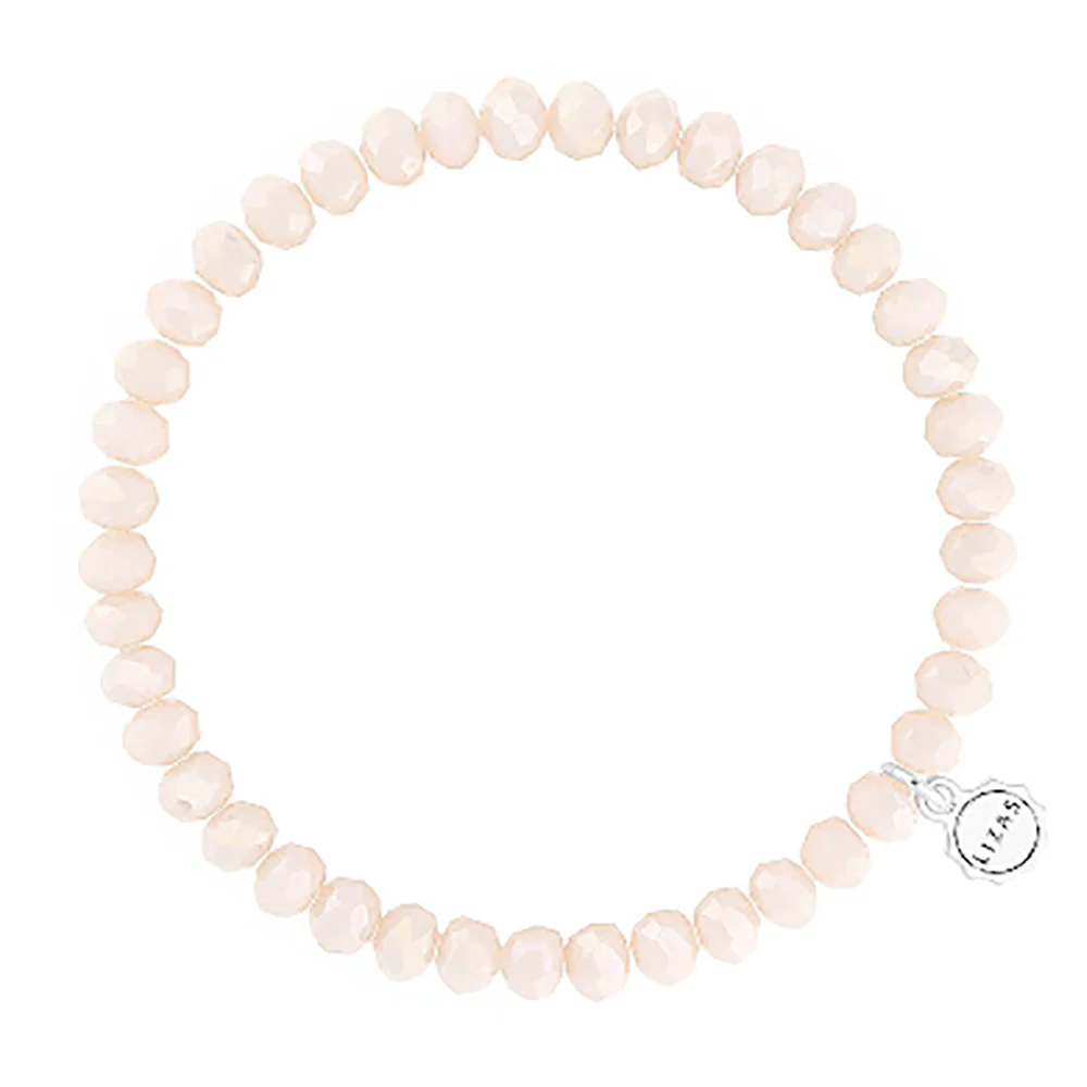 Lizas Quadro Big crystal stretch bracelet in light peach with a silver logo charm.
