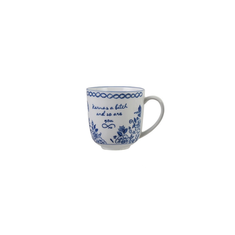Blue and white stoneware mug with floral patterns and the text "Karma's a bitch and so are you".