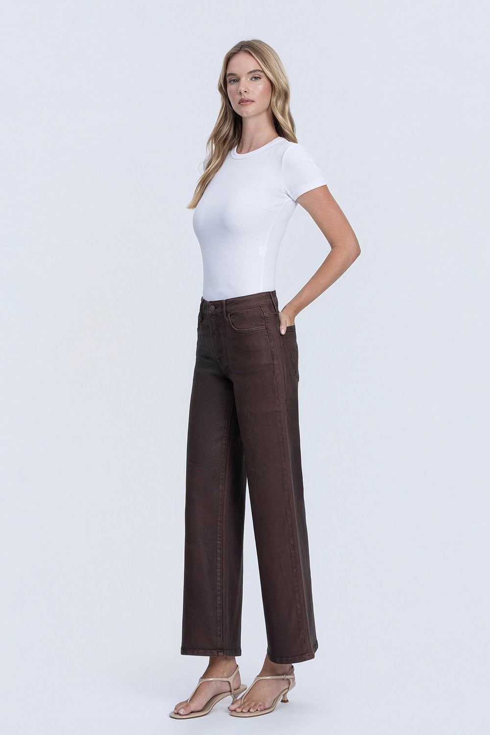 Model wearing Kitty High Rise Coated Wide Leg Jeans in dark brown with a white t-shirt.