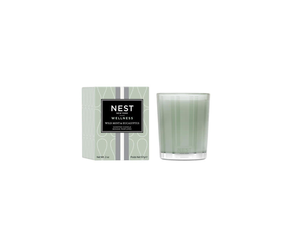 Nest Votive Candle in a clear glass holder with a white wax pillar.