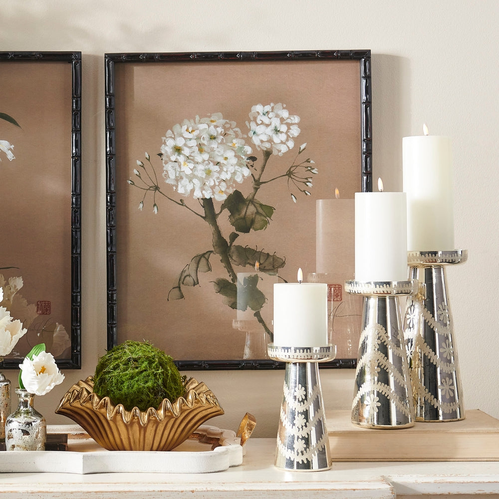 Etched silver mercury glass candle holder with a reflective finish.