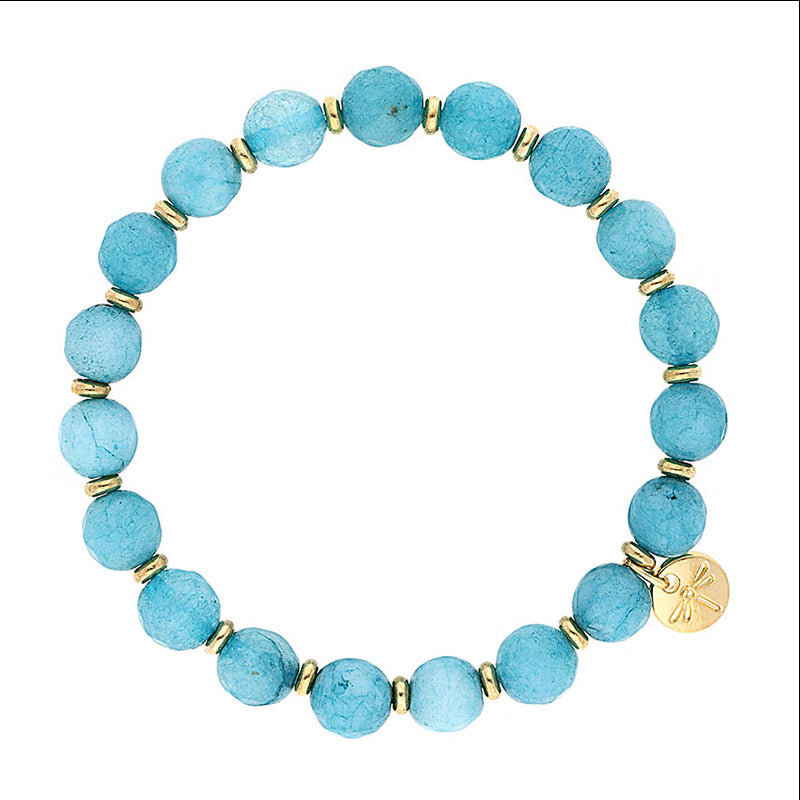 Lizas Beaumont Natural Bracelet featuring light blue stones, gold spacers, and a dragonfly charm.