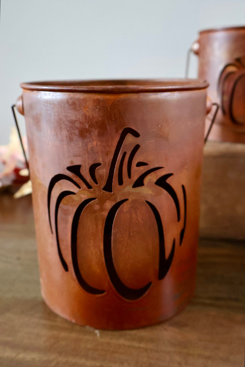 Rust-colored pumpkin-shaped bucket with a handle.