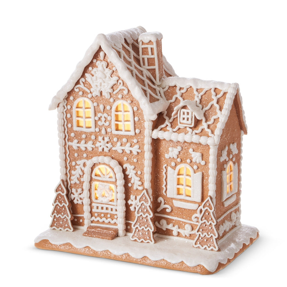 12.5-inch lighted gingerbread house made of clay dough with white icing details and warm glow.
