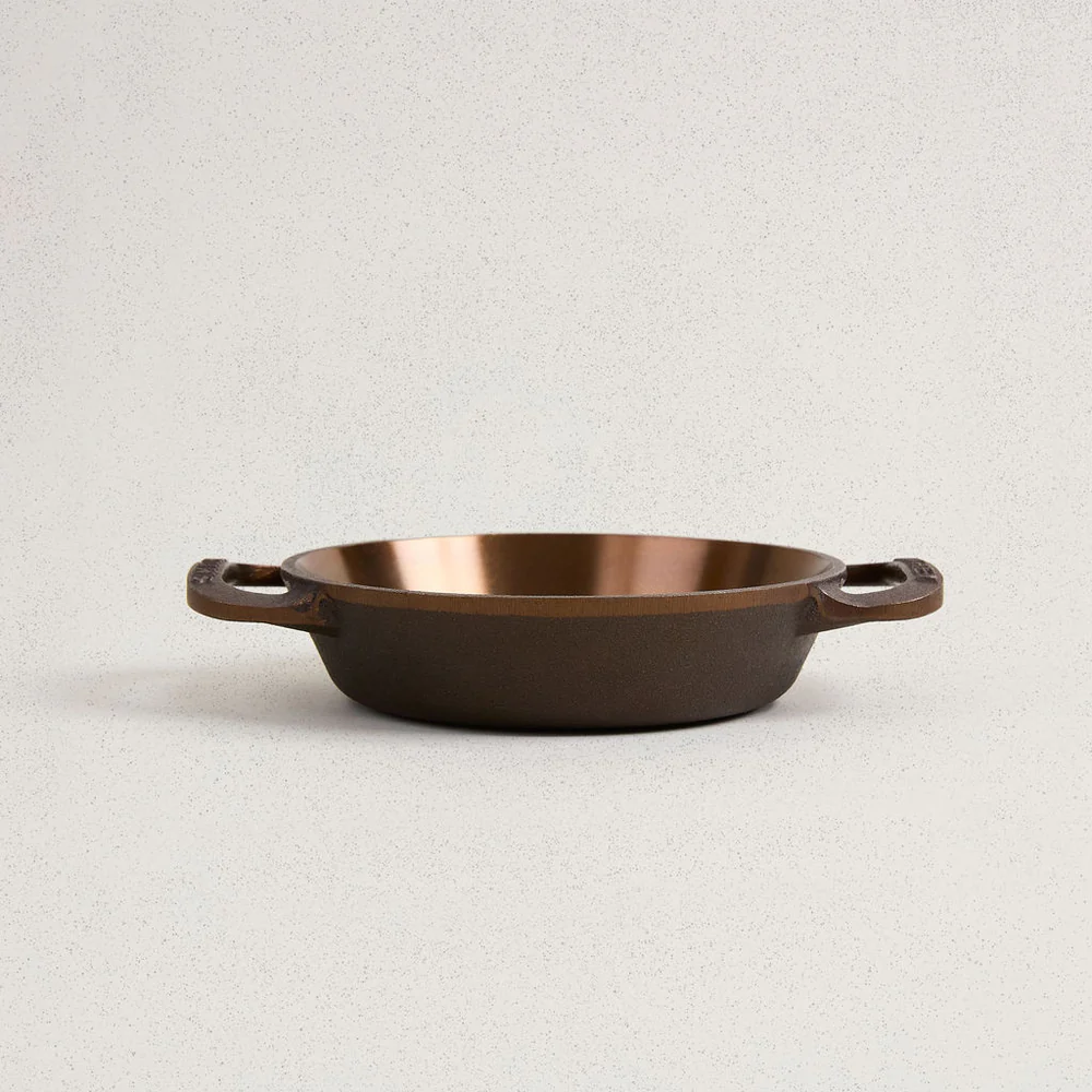 No. 6 Dual Handle Skillet with a polished copper-colored interior and dark cast iron exterior.