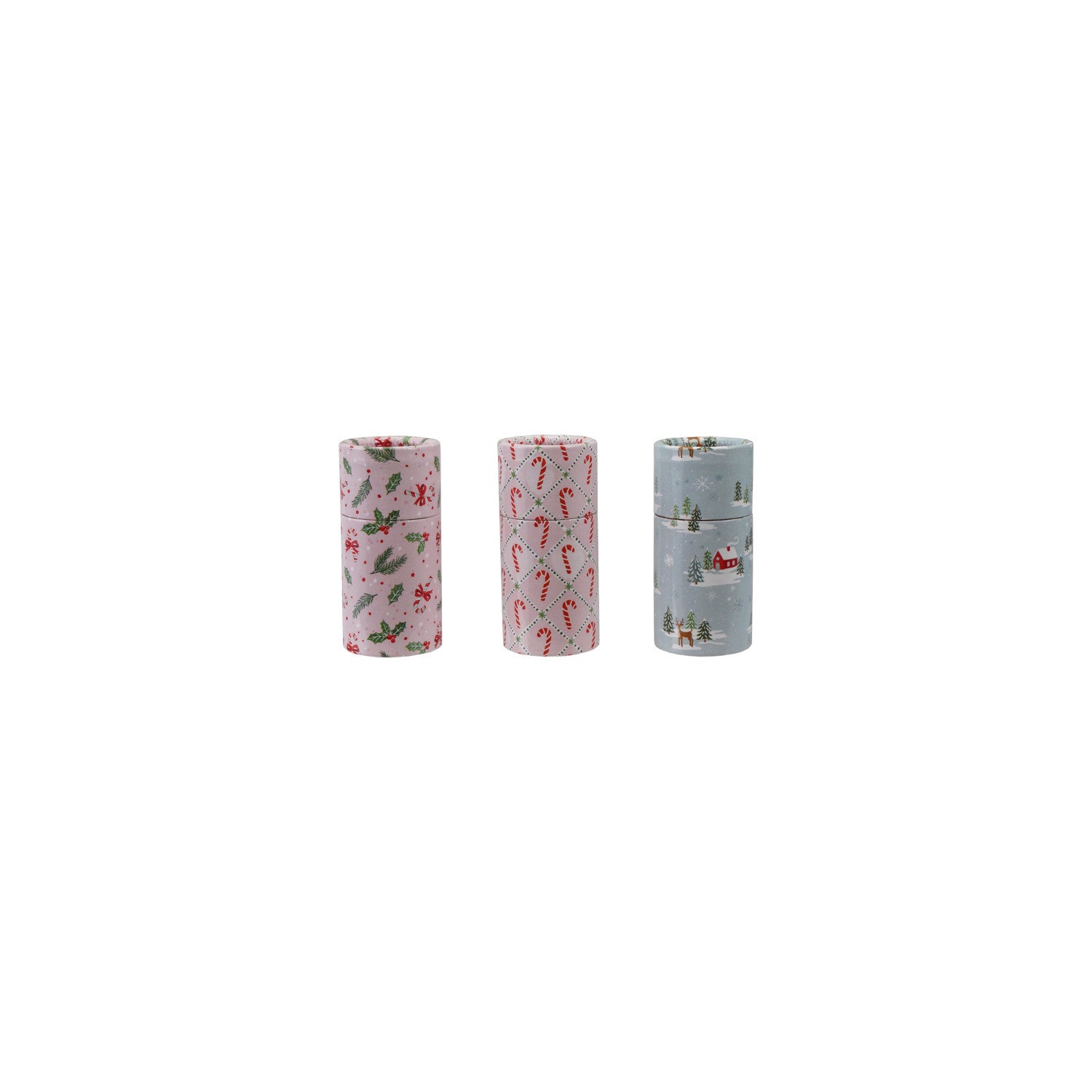 Three small tube matchboxes with holiday patterns: holly on pink, candy canes, and a winter scene.