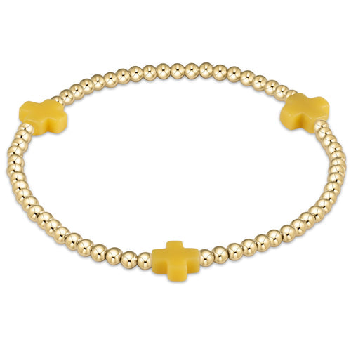 3mm gold-filled bead bracelet featuring a signature cross pendant on elastic cord