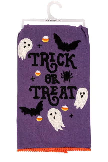 Cotton Halloween kitchen towel with orange pom trim featuring a Trick Or Treat pattern.