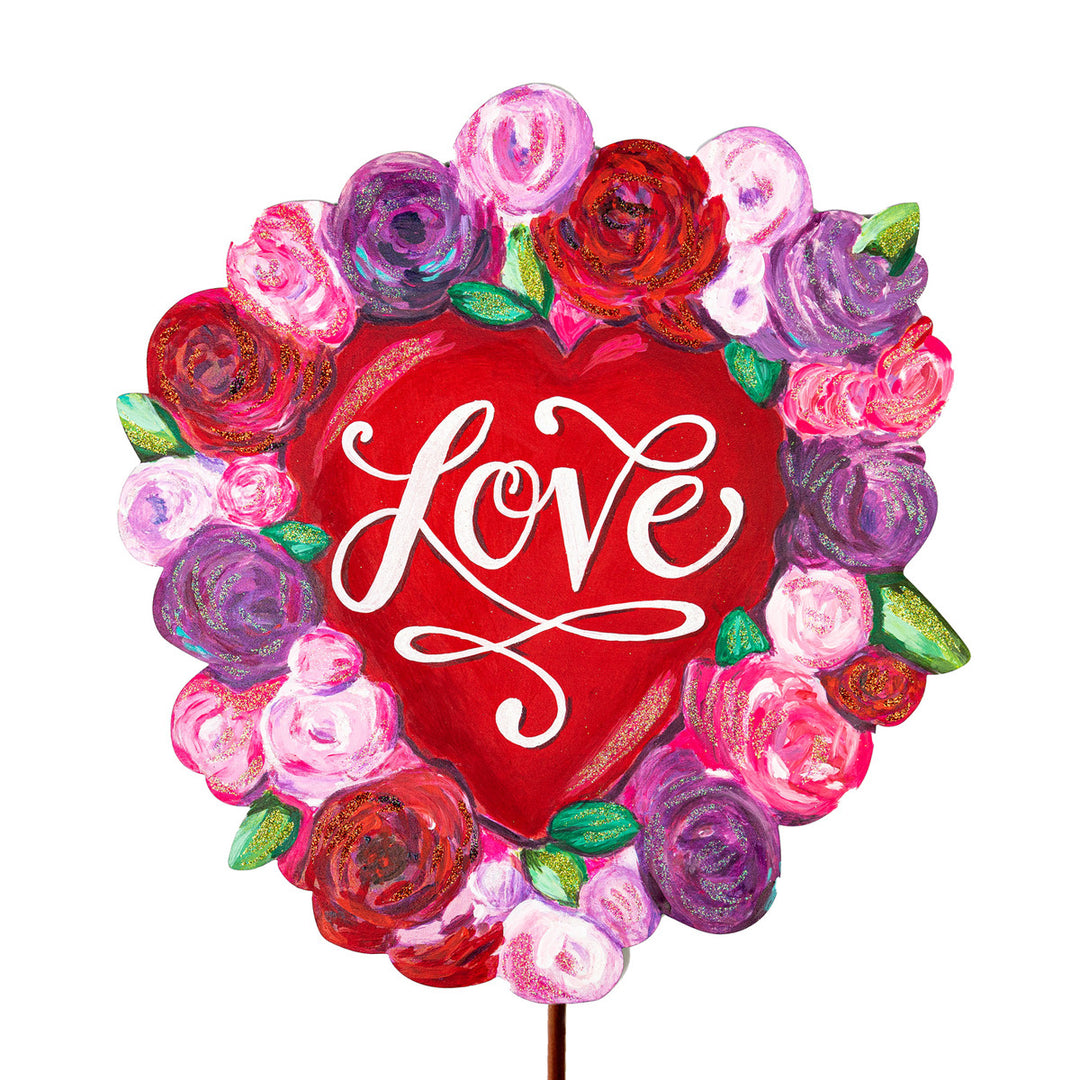 Floral heart-shaped sign with 'Love' text in a botanical pattern