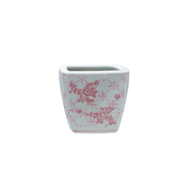 Square white stoneware planter with a pink floral lattice pattern.