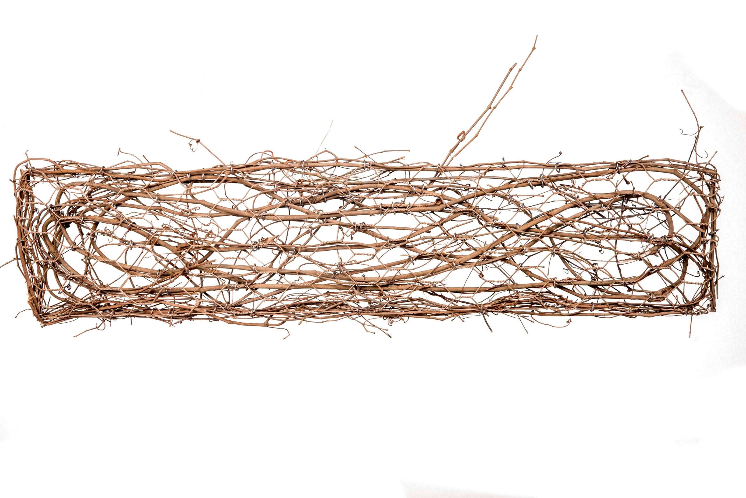 36-inch grapevine door decor in natural brown with a vertical vine silhouette.