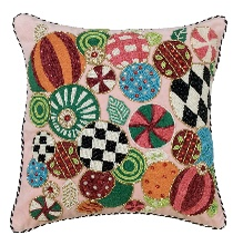 Pink throw pillow featuring colorful beaded Christmas ornament designs in various patterns.