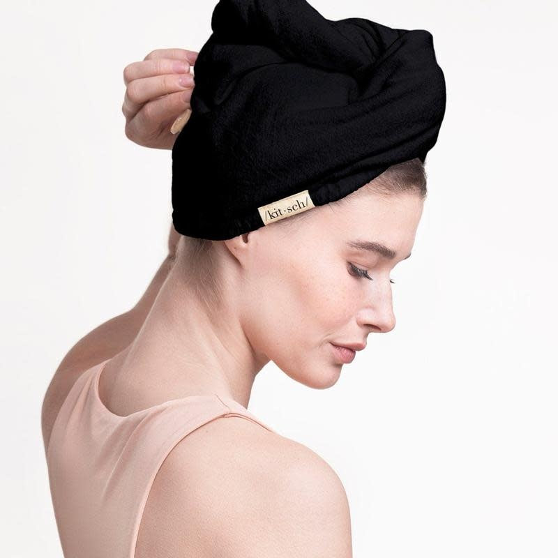 Black eco-friendly quick dry hair towel made from organic cotton and bamboo with stretch elastic trim.
