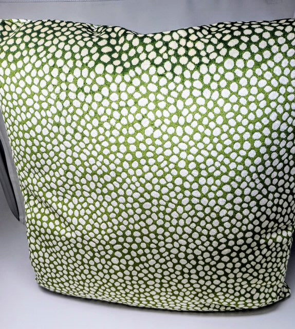 A 24x24 hand-crafted pillow with a green and white dot pattern.