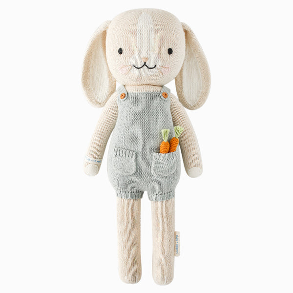Hand-knit Henry the Bunny stuffed toy in cream cotton with felt ears and signature wristband.