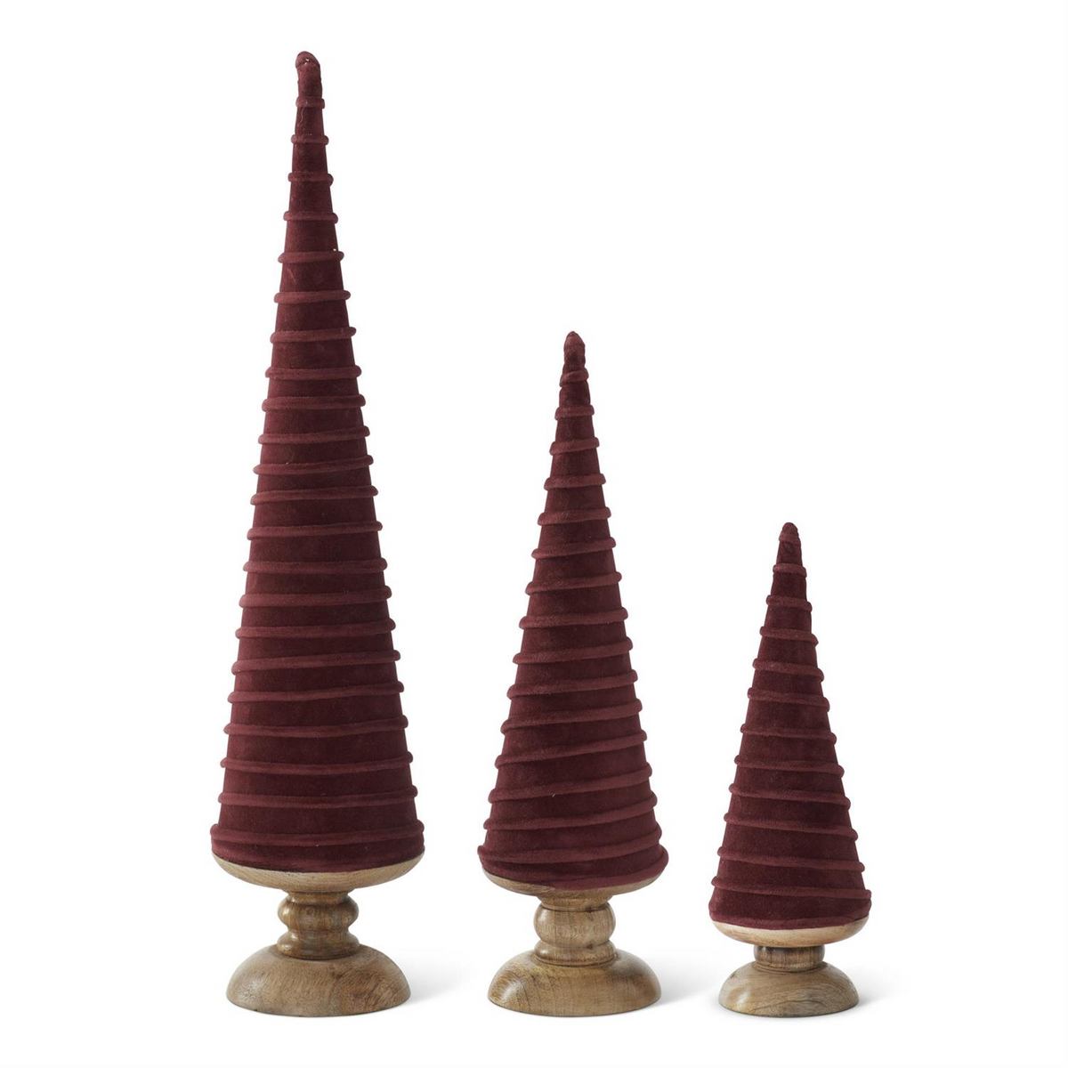 Three burgundy velvet Christmas trees with spiral detailing stand on round wooden pedestals.