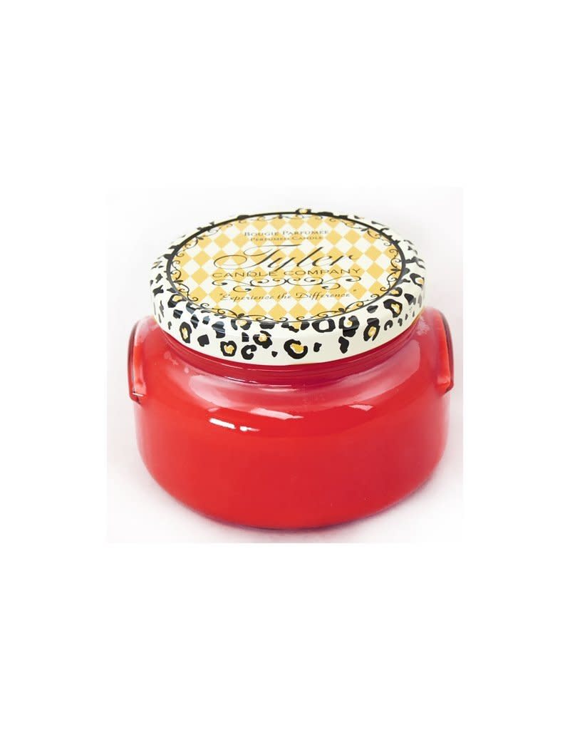 A clear glass jar containing a white soy candle with an unlit wick.