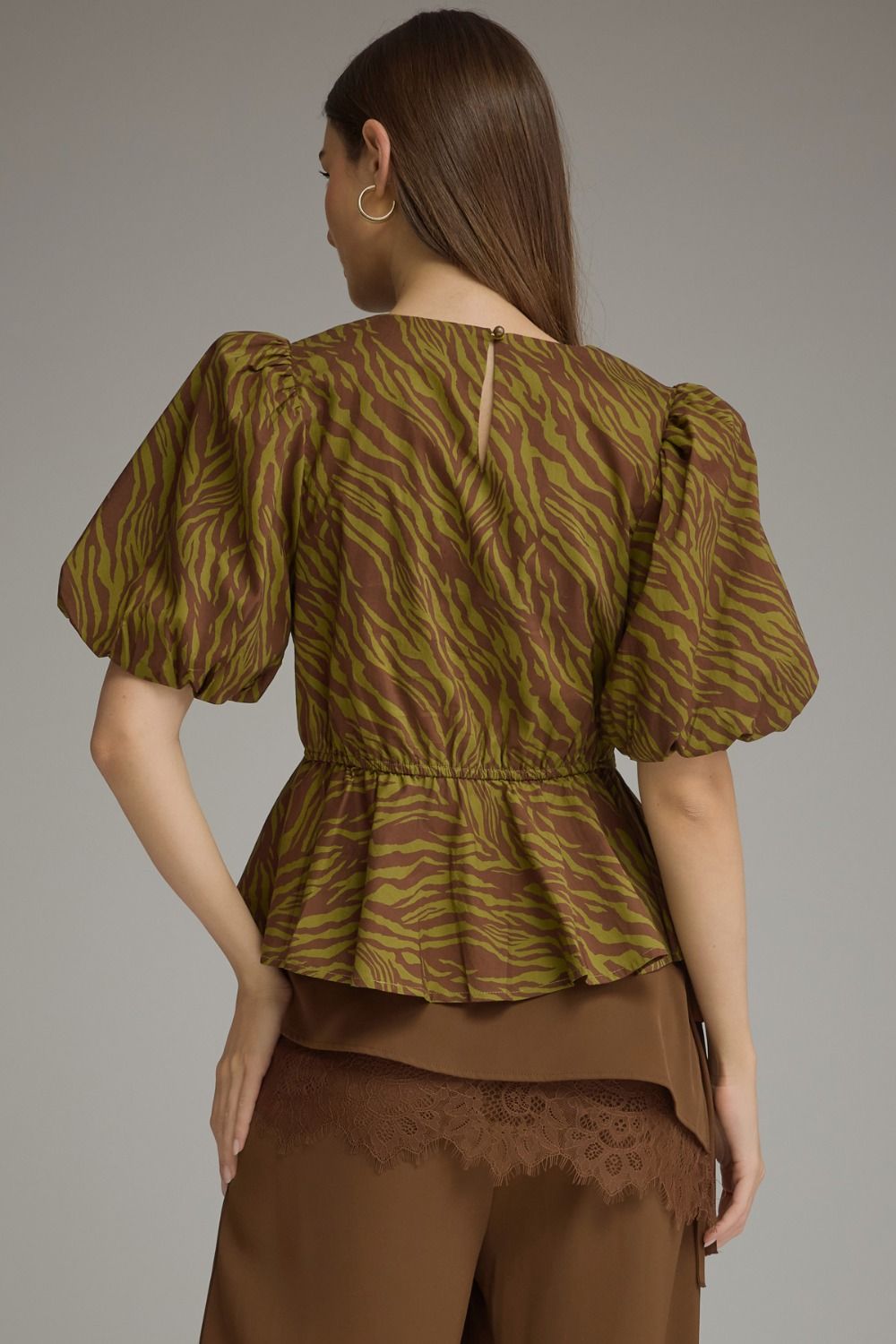 Back view of Serena top with brown and olive animal print, short puff sleeves, and peplum waist.