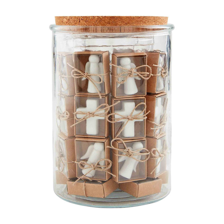 Glass jar filled with small boxed ceramic angel and cross charms tied with twine.