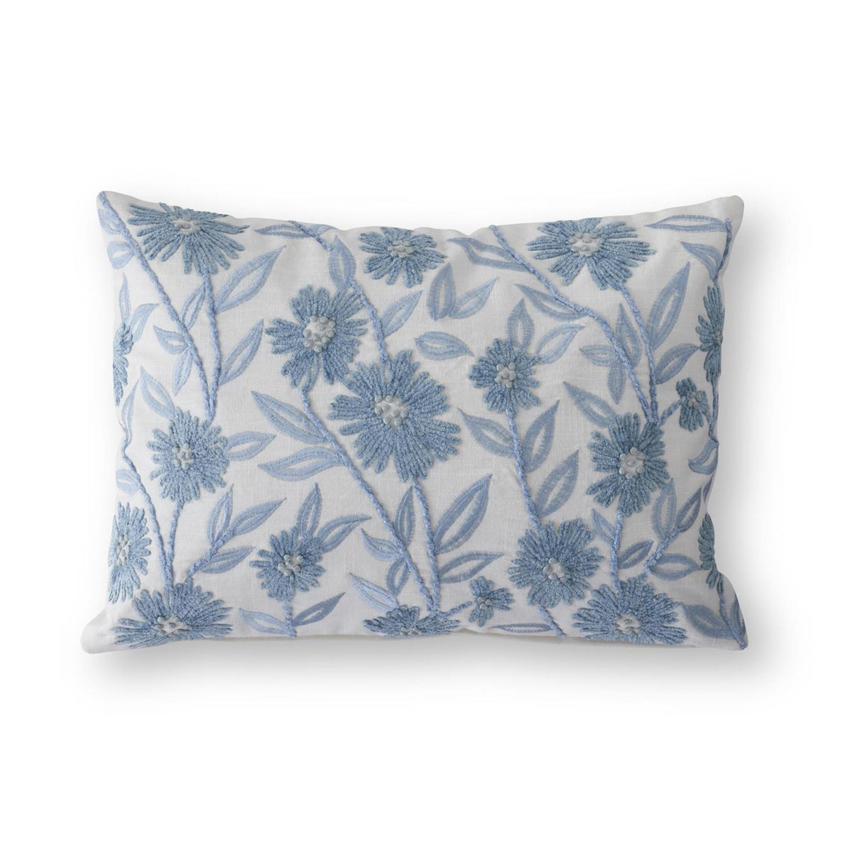 White linen lumbar pillow with blue embroidered floral pattern on a removable shell.