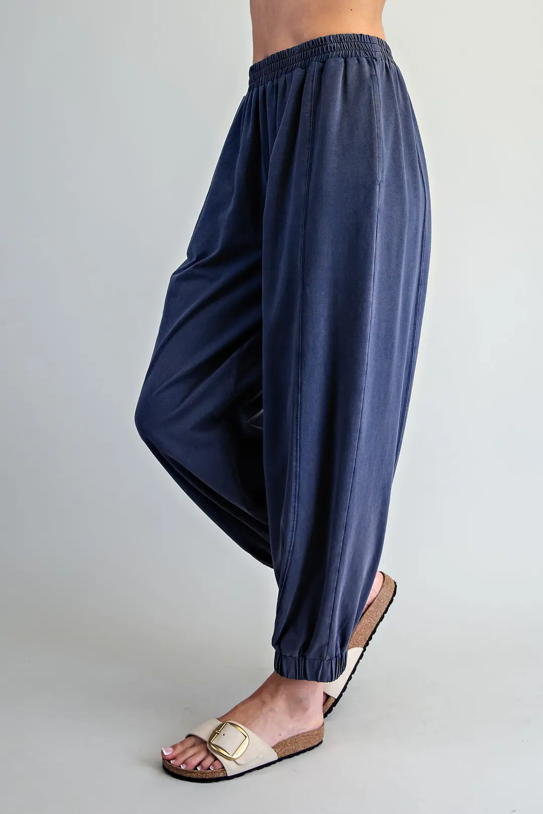 Navy blue Odette joggers with elastic waist, vertical panel seams, and tapered elastic cuffs.