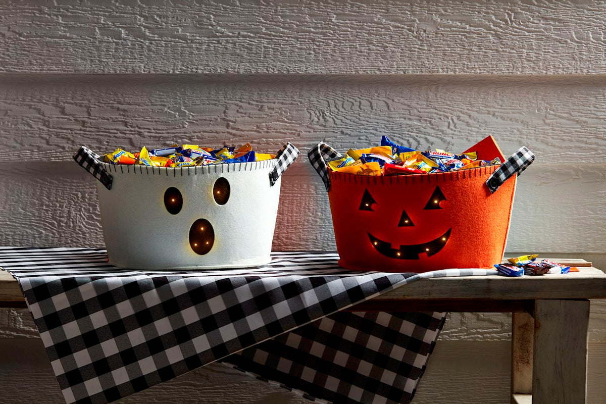 Reversible felt bucket with ghost on one side and jack-o-lantern pattern on the other.