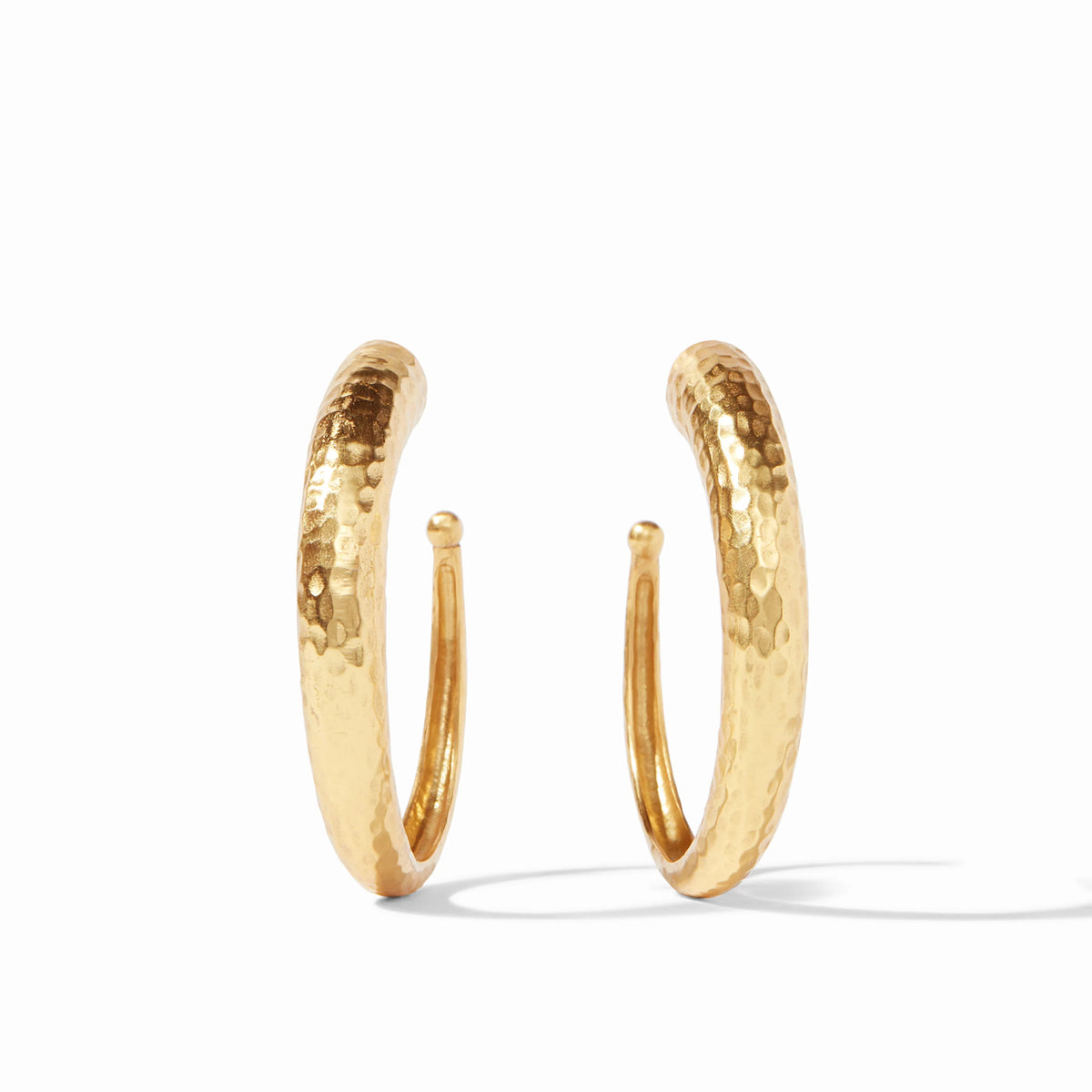 Pair of 24K gold plated hammered hoop earrings on a white background.