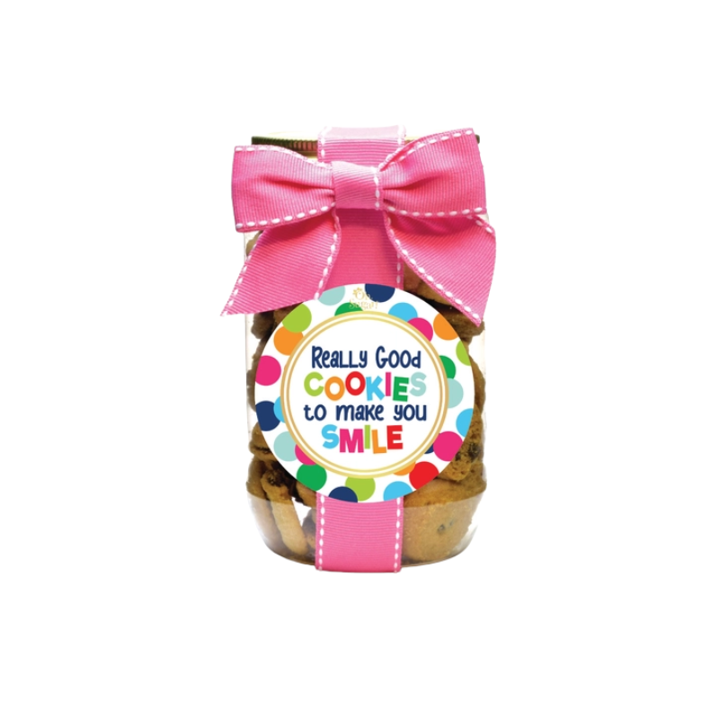 Pint-sized cookie jar with a pink ribbon and a colorful 'Really Good Cookies to Make You Smile' label