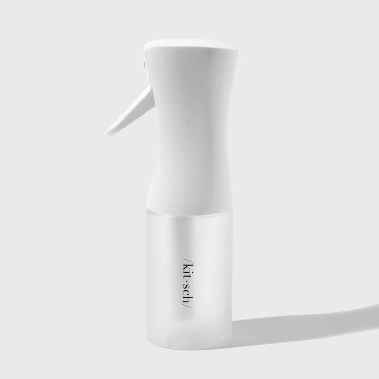 White recycled plastic continuous spray bottle with a compact cylindrical body.