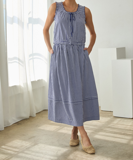 Audrey Gingham Midi Skirt in white with black checkered pattern featuring a classic A-line silhouette and side pockets.