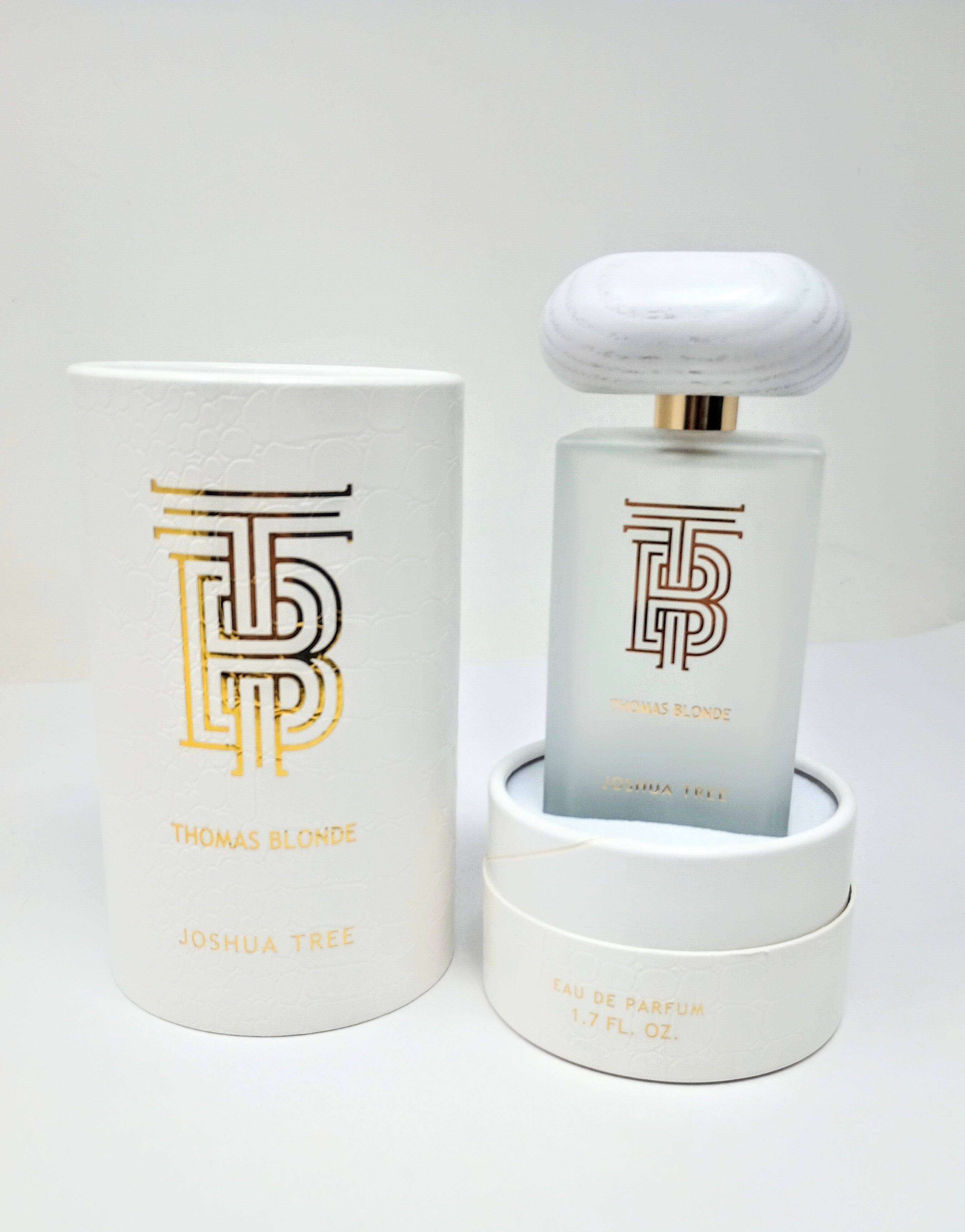 Bottle of Thomas Blonde Eau De Parfum in a clear glass container with blonde liquid.