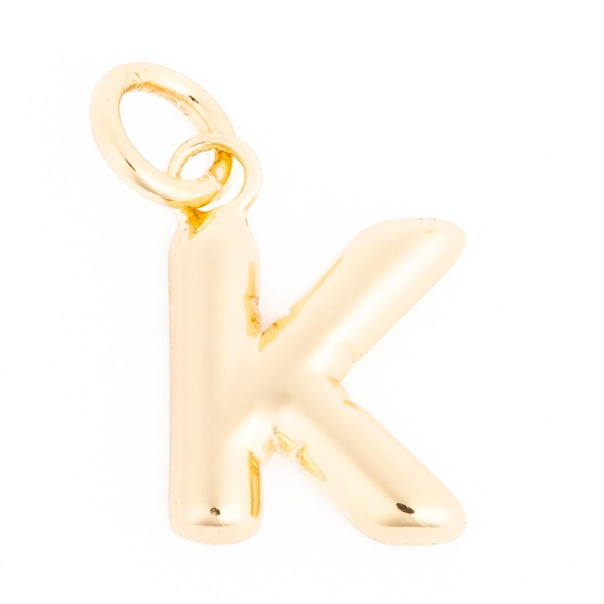 Gold-toned letter K charm with a polished, rounded finish and a small jump ring for attachment.