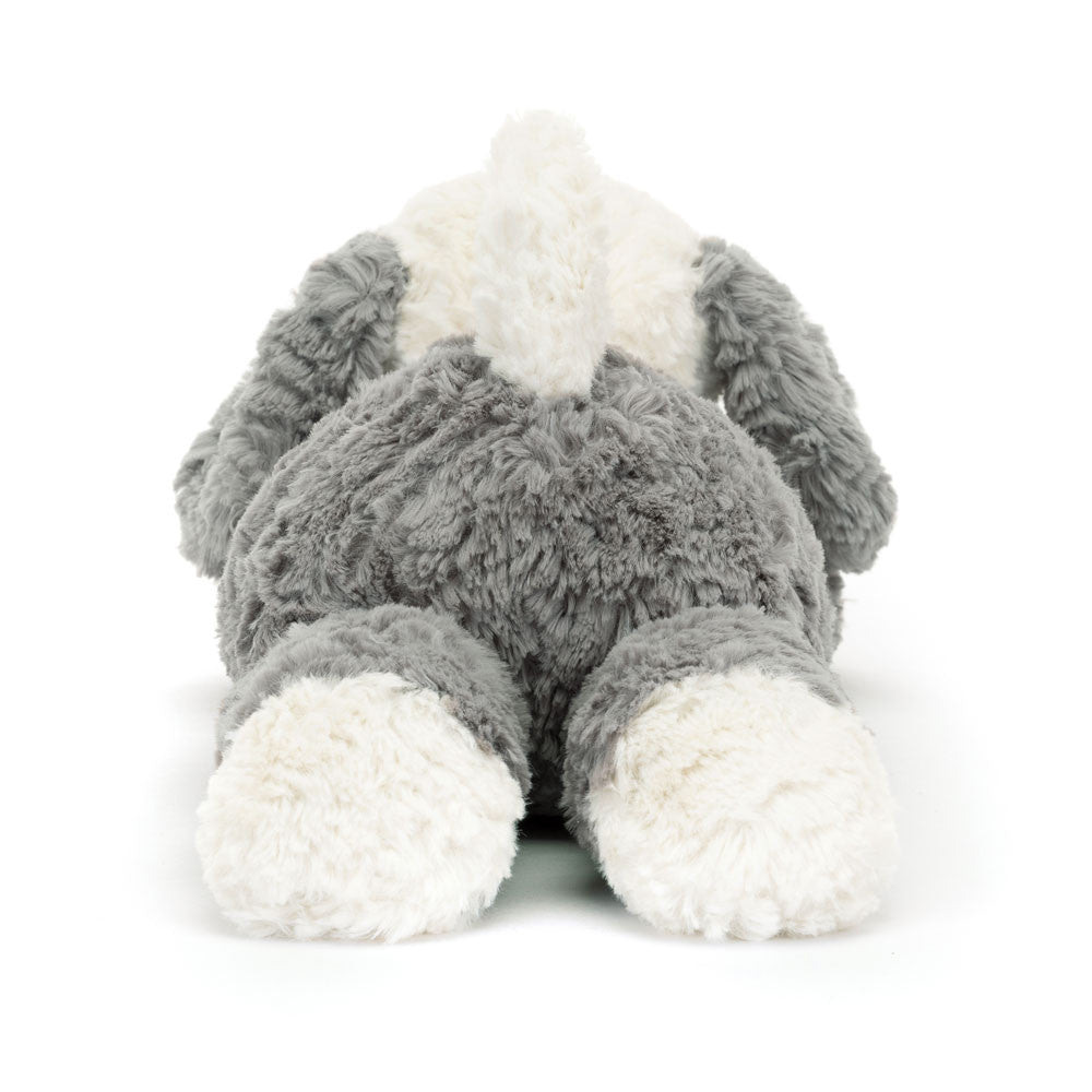 Rear view of a Tumblie Sheep Dog plush toy in grey and white fur lying down.