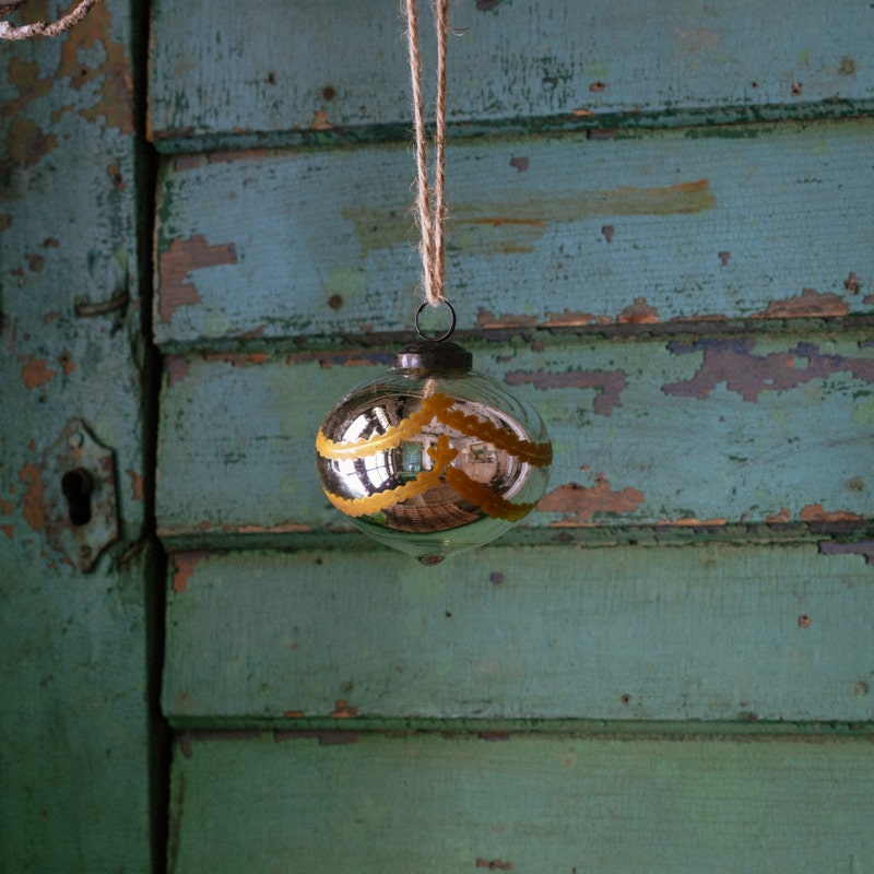 Venetian Glass 4-inch onion-shaped ornament with silver finish and yellow scalloped trim.
