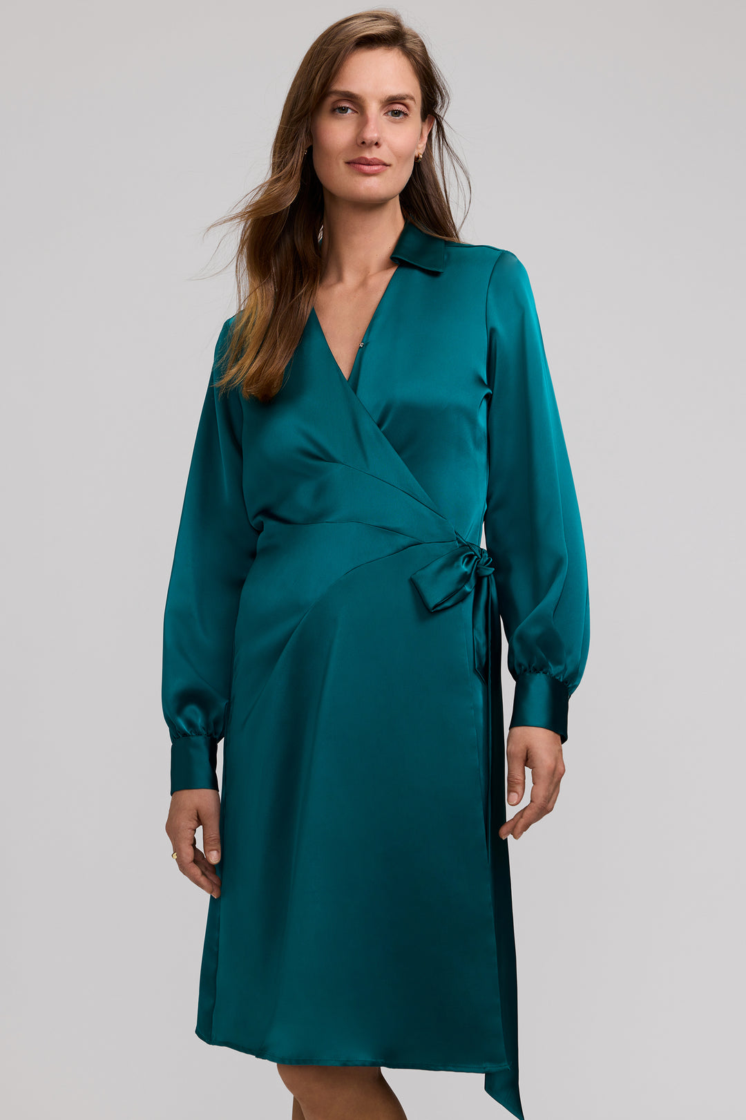 Woman wearing the Valentina long sleeve glossy teal satin wrap dress with a collared neckline.