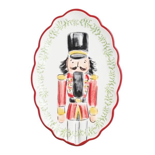 Oval white dolomite platter with a red scalloped edge, featuring a hand-painted nutcracker design.