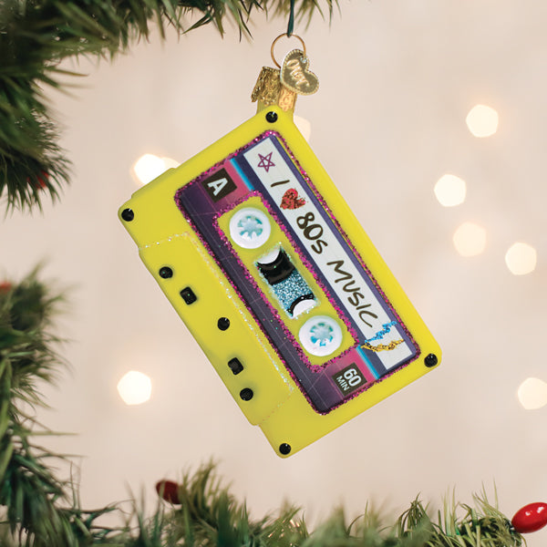 80s-themed ornament featuring a retro cassette tape shape in red with black accents and silver metallic finish.