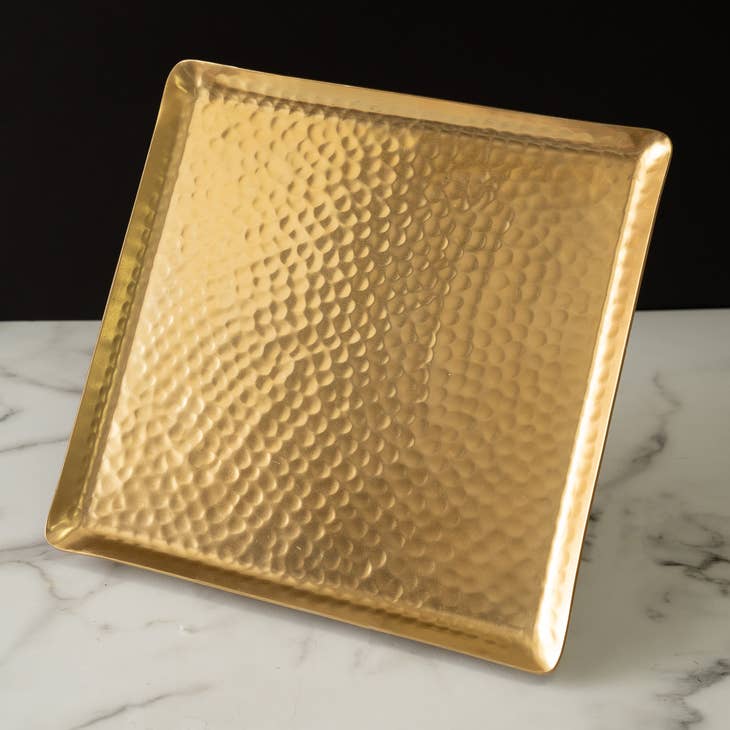 Gold square hammered plate made of aluminum, displayed on a marble surface.