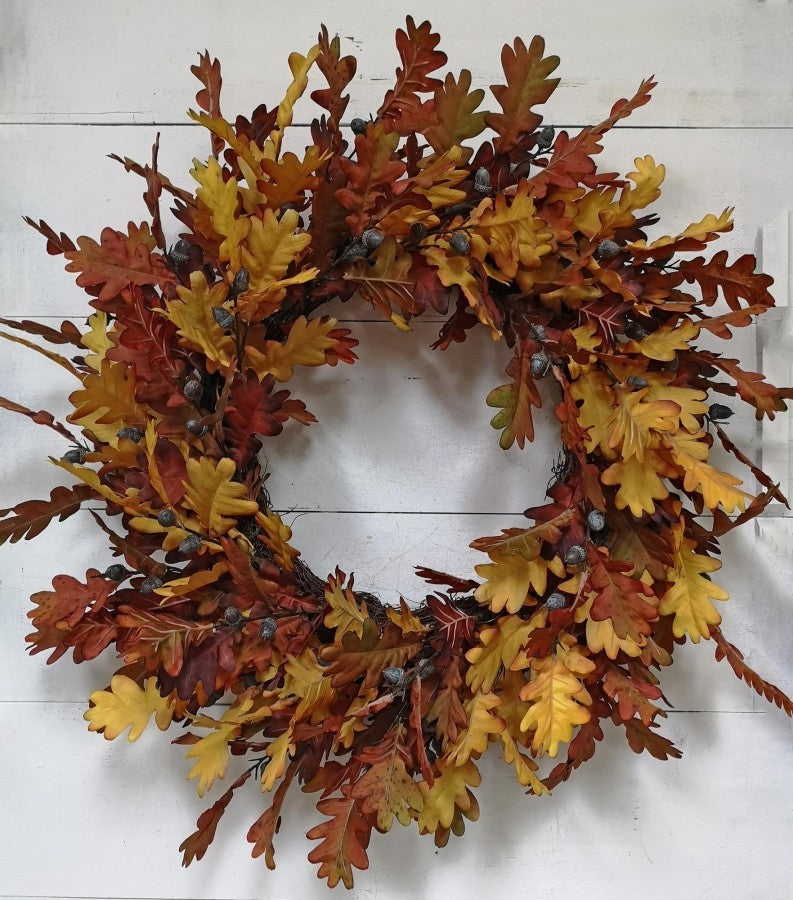 30-inch autumn wreath featuring layered oak leaves in shades of gold, orange, and rust with acorns.