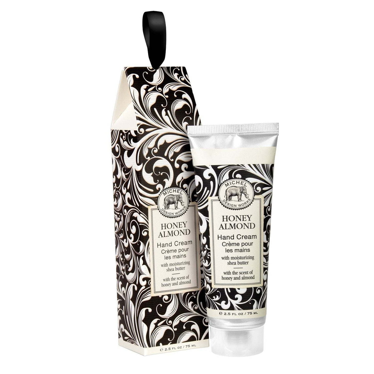 Michel Design Works Honey Almond hand cream tube and matching gift box with black floral pattern.