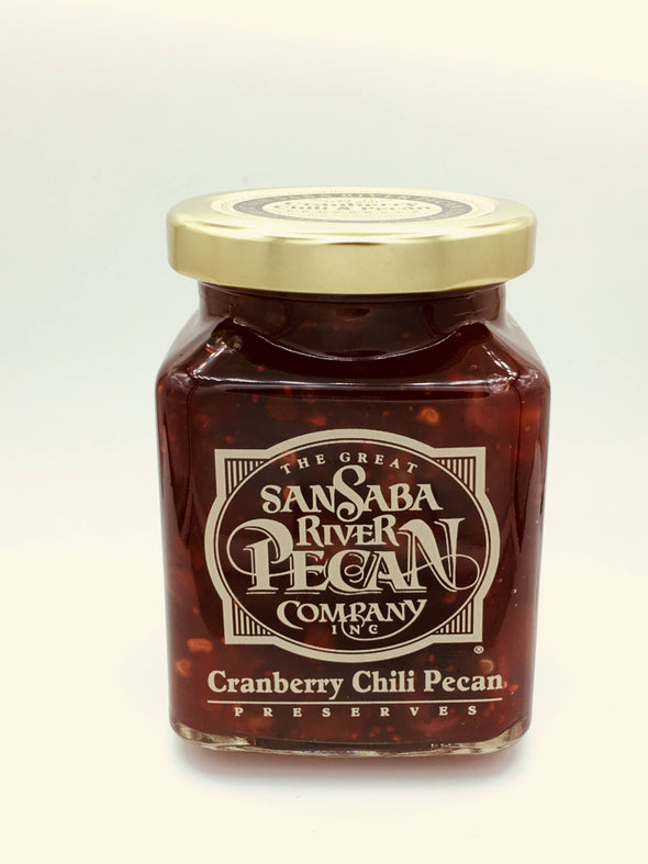 Glass jar containing Texas cranberry preserves with pecans