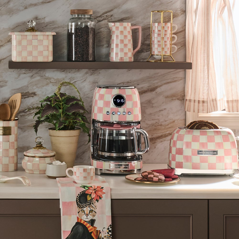 Rosy Check Drip Coffee Maker on a kitchen counter with matching pink checkered appliances.
