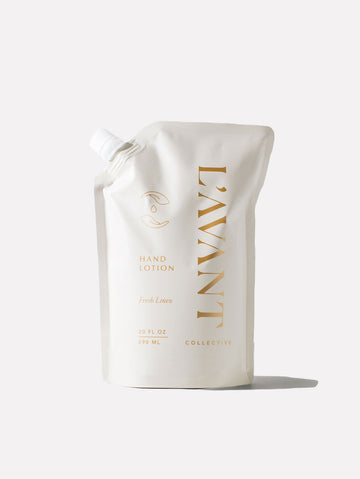 L'AVANT Collective Fresh Linen Hand Lotion Refill in a 20 fl oz white stand-up pouch with gold text.