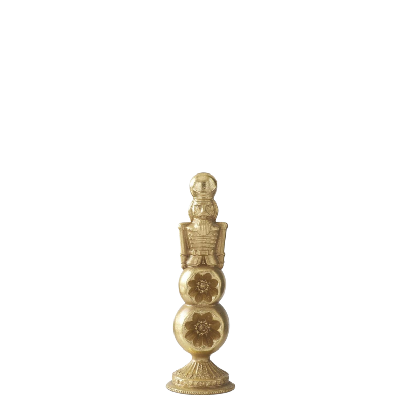 Gold nutcracker figure standing on a tiered, floral-carved ornament finial base.
