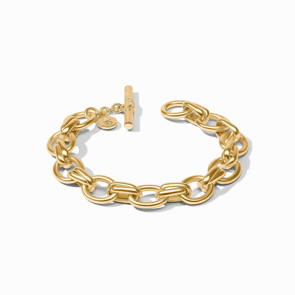 Gold Essex Link Bracelet with a toggle clasp and a small round charm on a white background.