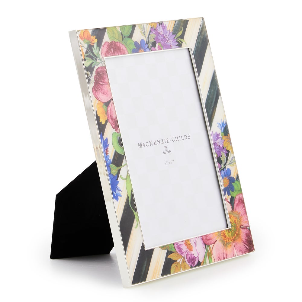 Silver-plated rectangular frame with a floral market print on the front.