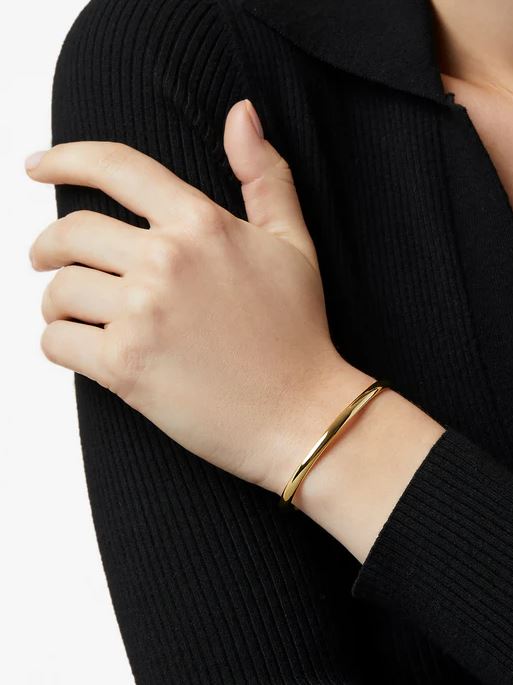 Open gold bangle bracelet with a simple band design.